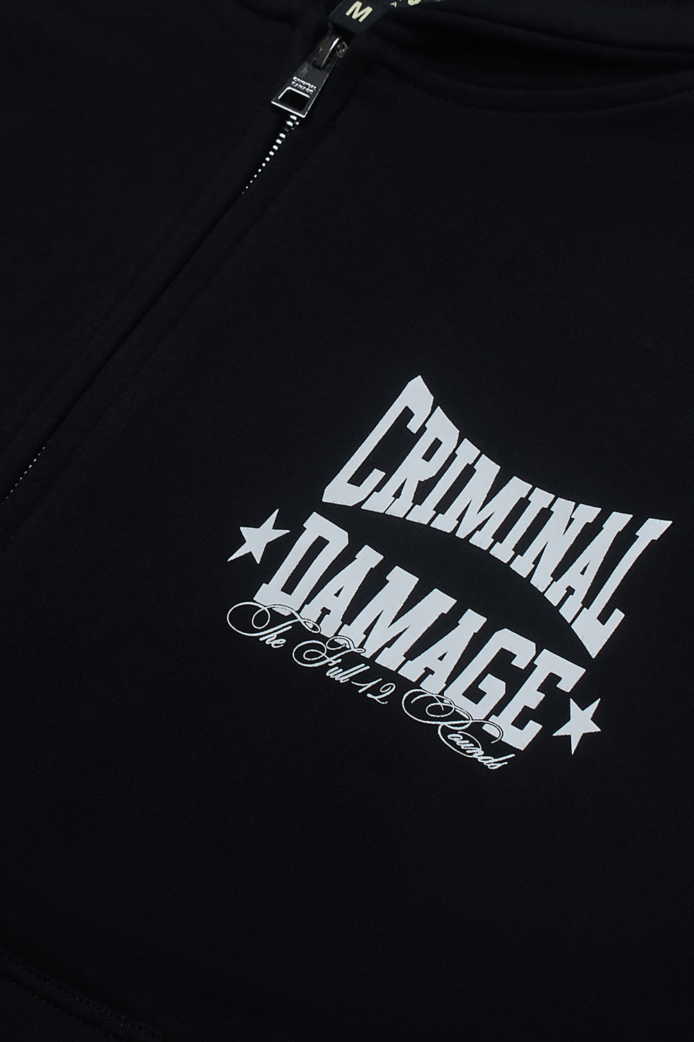 Close up of Criminal Damage graphic logo on hoodie