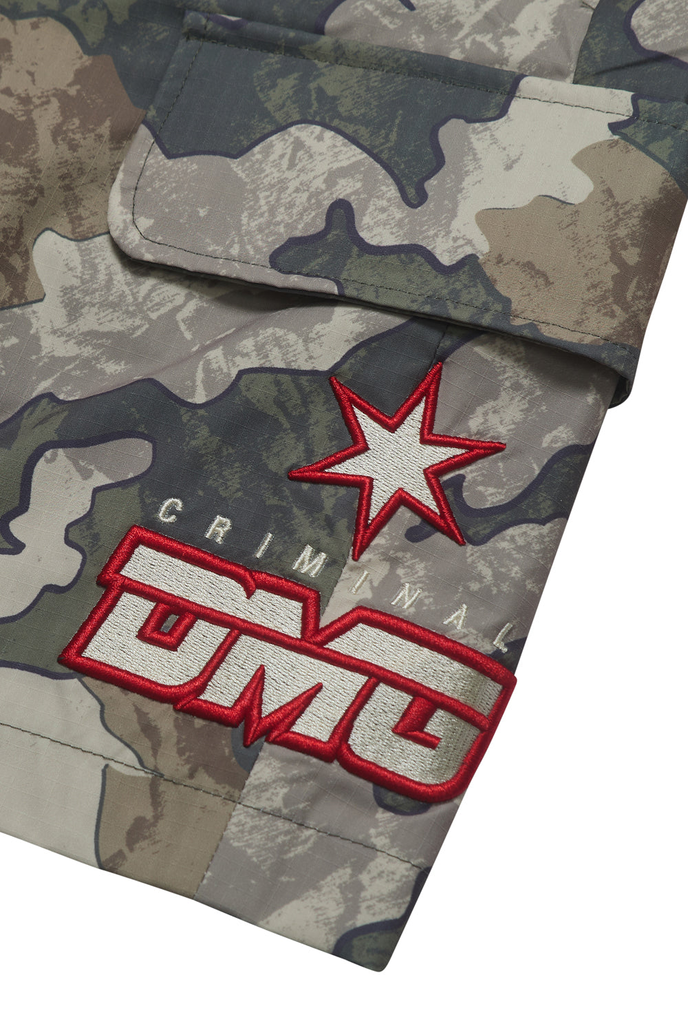 Close up of Criminal Damage embroidered patch logo on white background