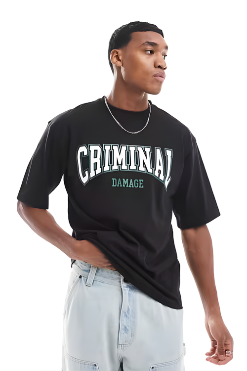 Person wearing a black t-shirt with 'CRIMINAL DAMAGE' text on a white background
