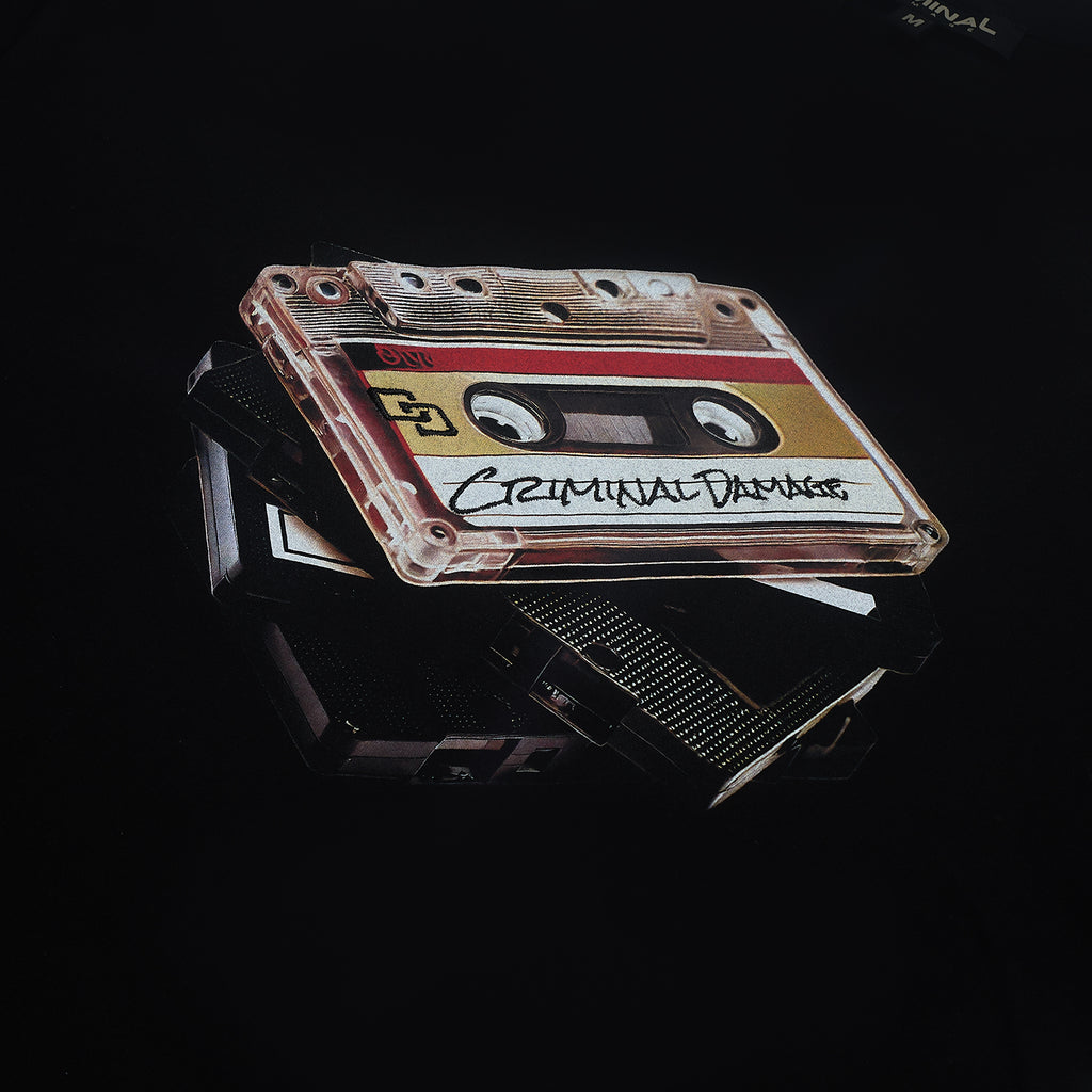 Black Criminal Damage T-shirt with Cassette tape graphic on a black background