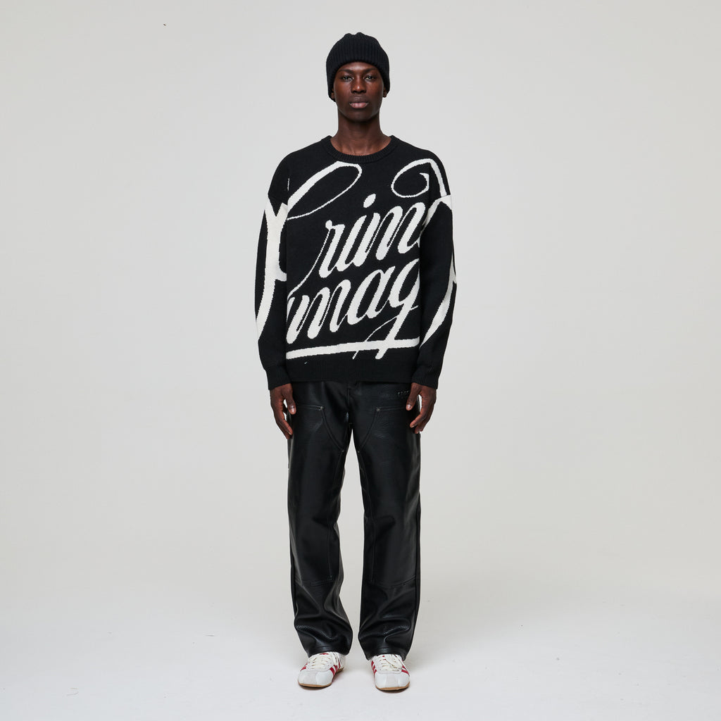Person wearing a black sweater with white text on a plain background