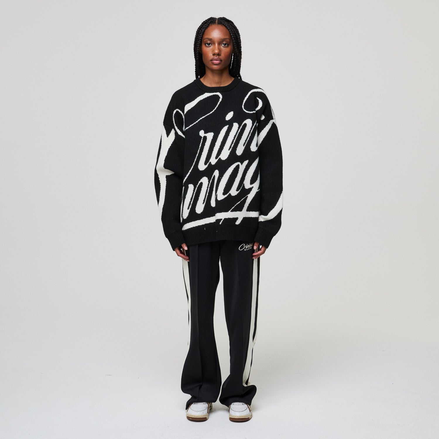 Person wearing a black and white outfit with 'rin may' branding on a plain background