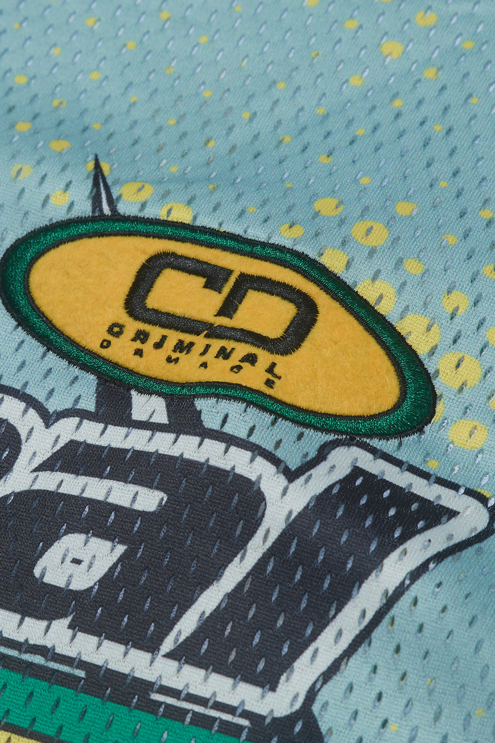 Close up of Criminal Damage embroidered patch on jersey