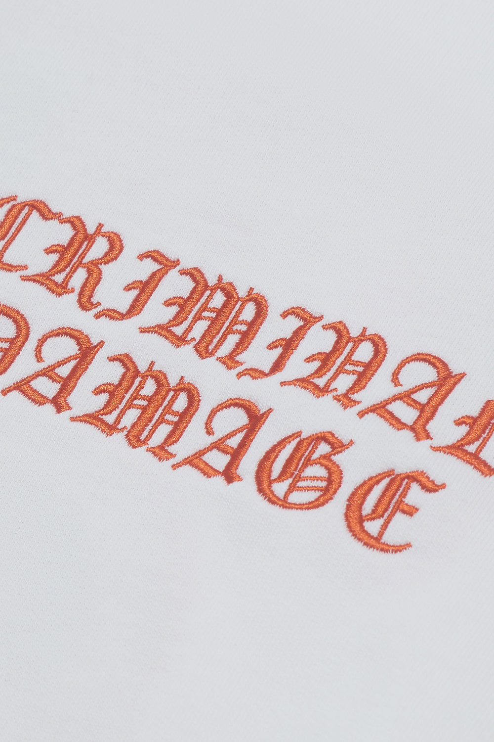 Close up of Criminal Damage embroidered logo on crewneck