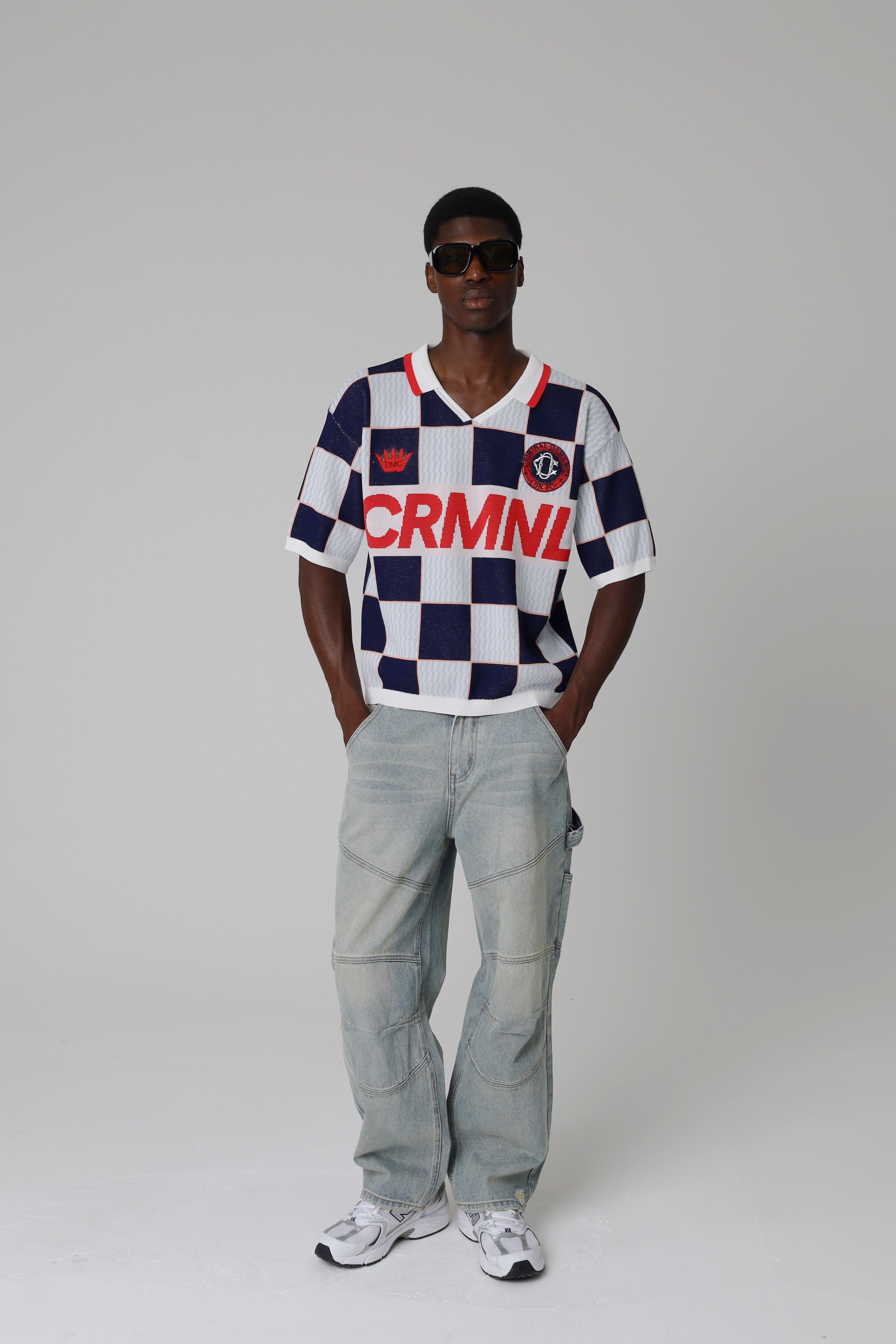 Person wearing a Criminal Damage checkered jersey on a grey background