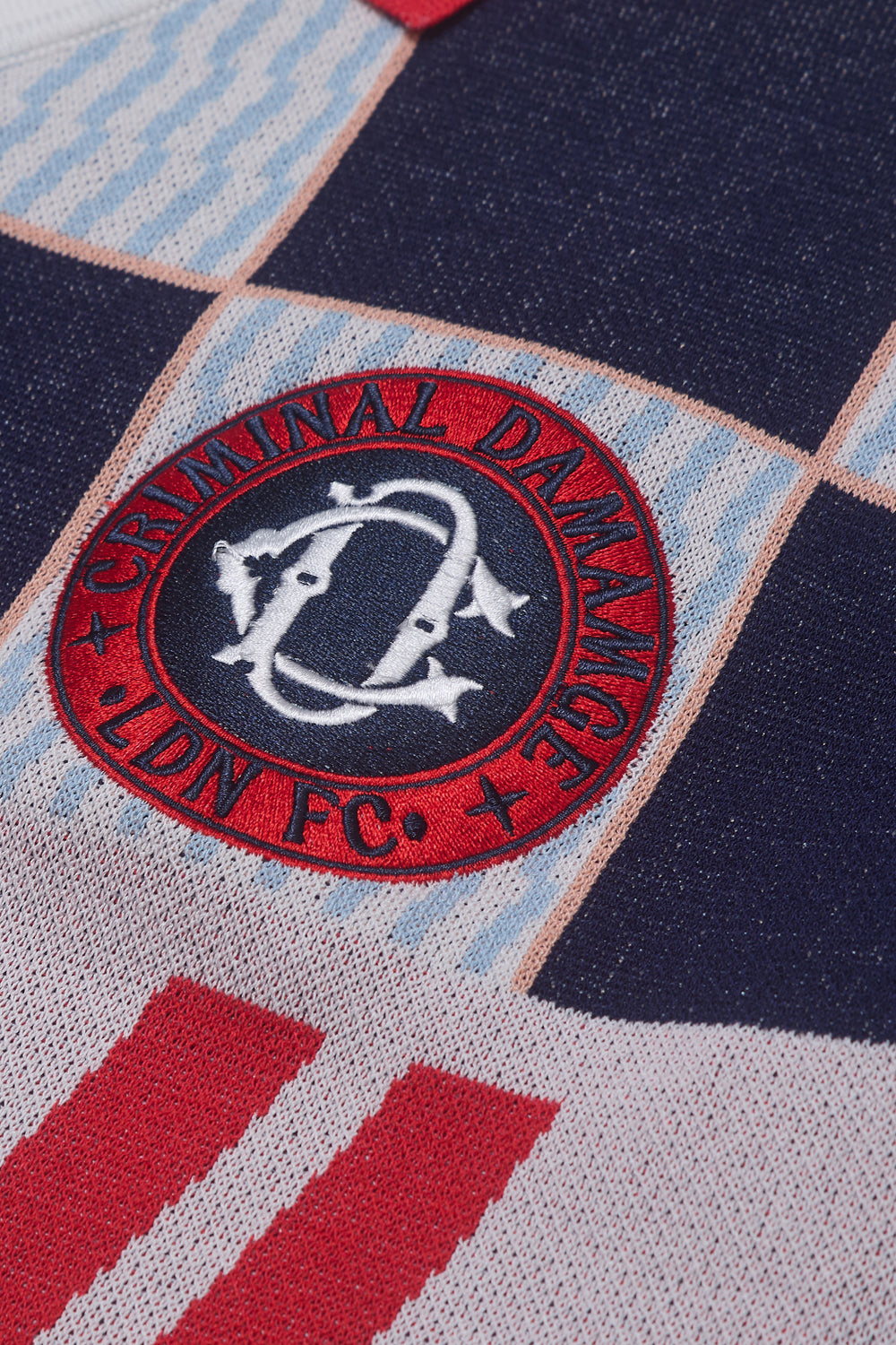 Close up of Criminal Damage logo on football jersey