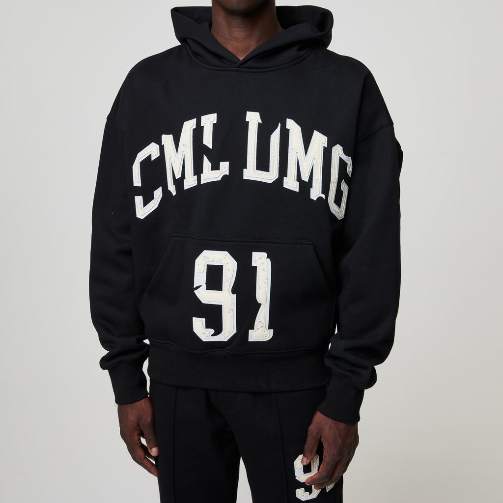 Black hoodie with 'CML LMG 91' text on a plain background