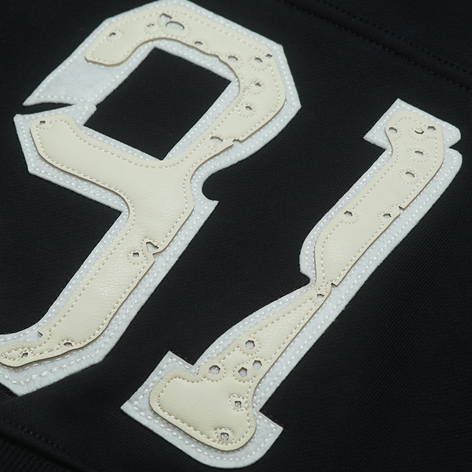 Black hoodie with patch on a dark background