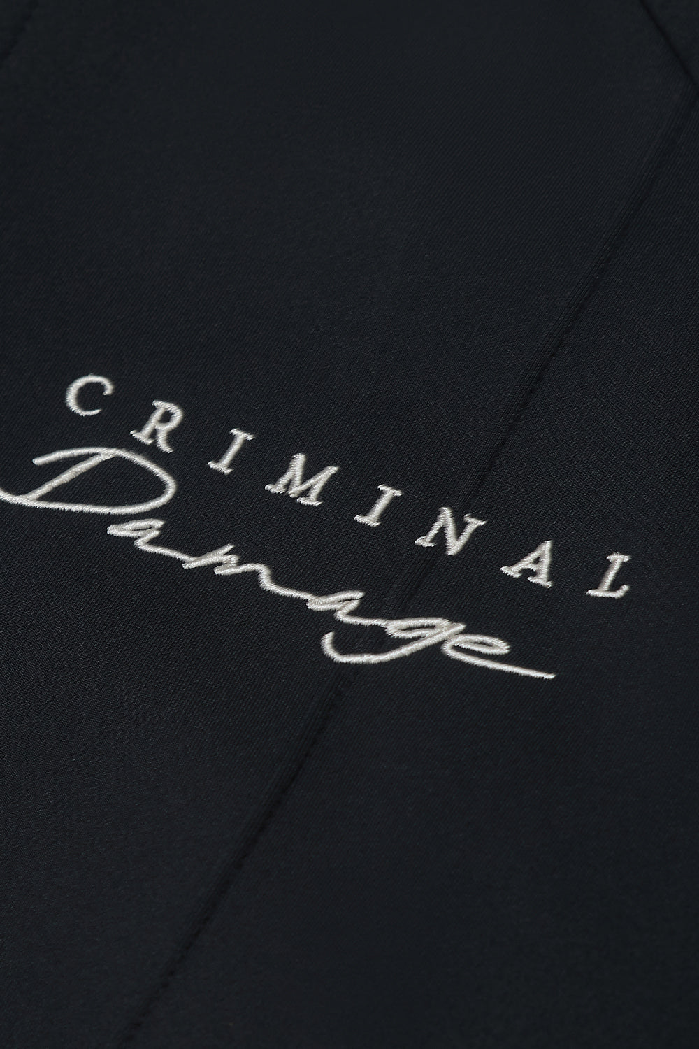 Close up of Criminal Damage logo on jacket