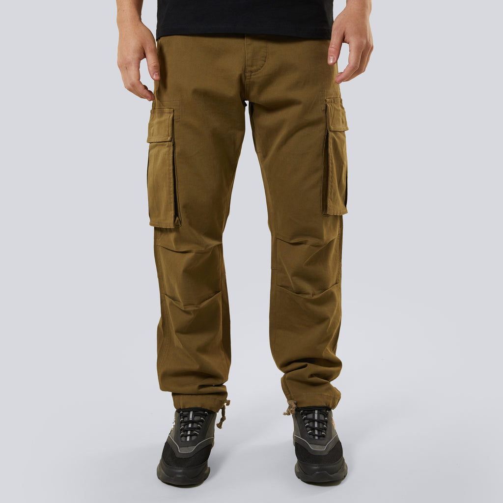 Brown cargo pants worn by a person on a white background