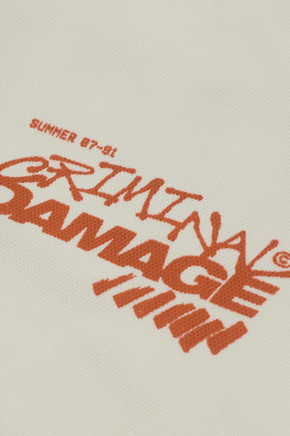 Close up of Criminal Damage branding on t-shirt