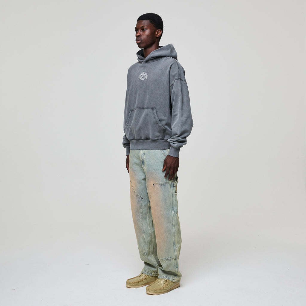 Person wearing a gray Criminal Damage hoodie and light blue jeans on a white background