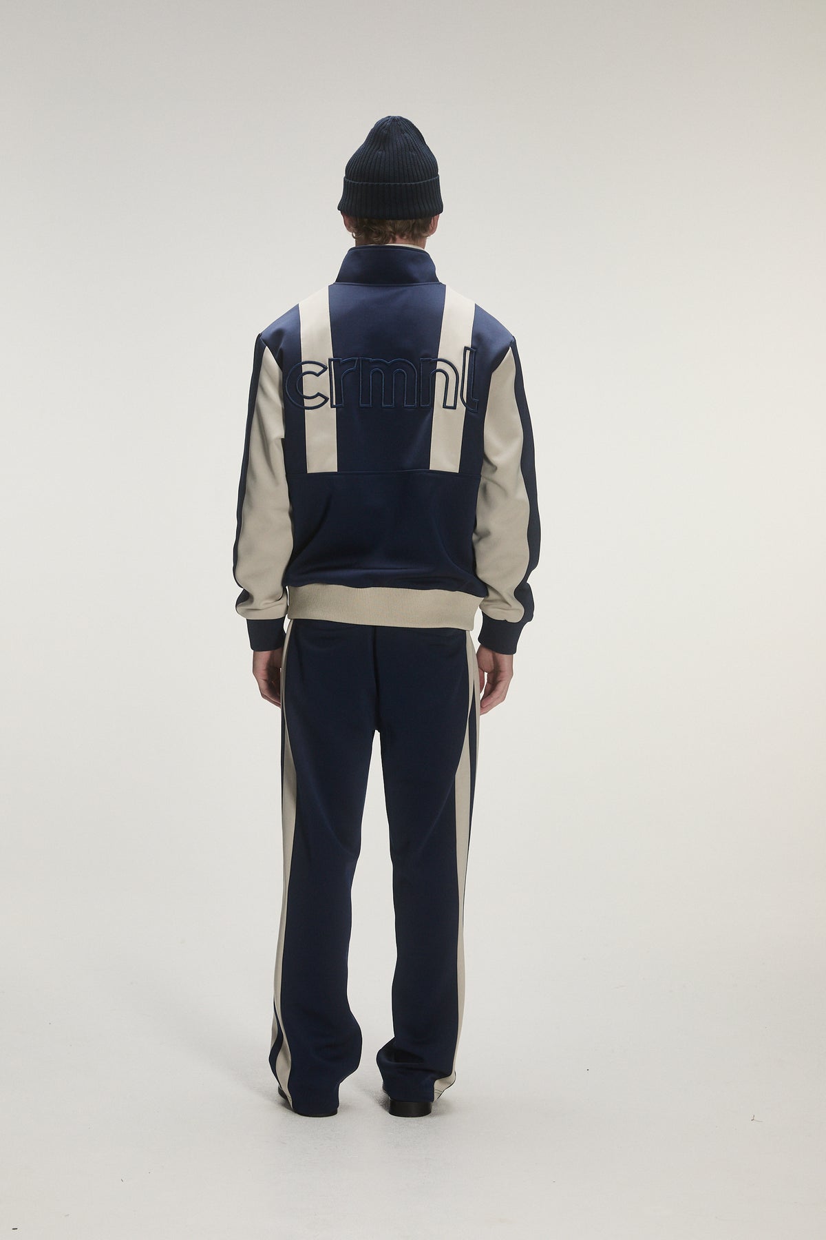 Male model wearing criminal damage on white background 