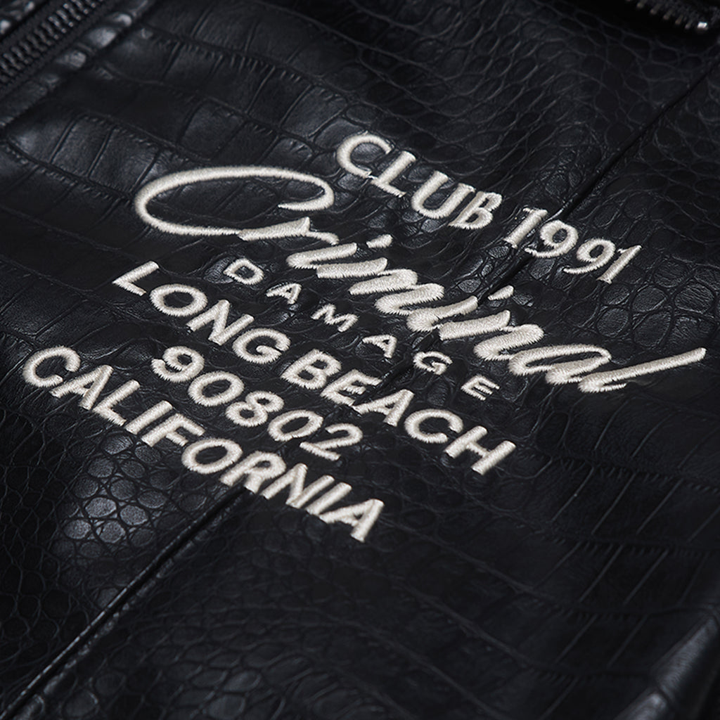 Black leather bag with white text 'CLUB 1991 CRIMINAL DAMAGE LONG BEACH 90802 CALIFORNIA' on a textured black background.