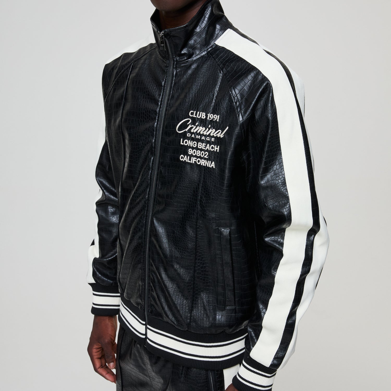 Black leather jacket with white text and accents on a gray background