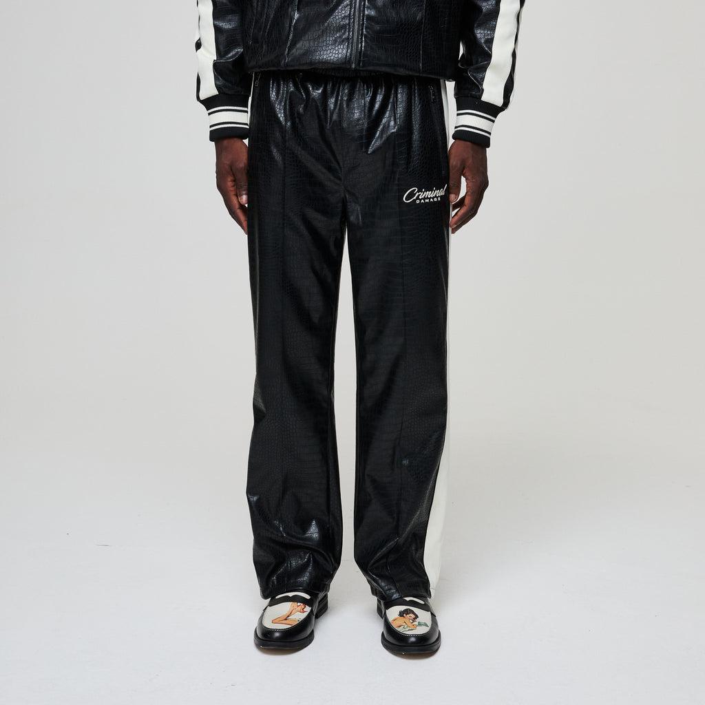 Black tracksuit with 'Criminal Damage' branding on a white background