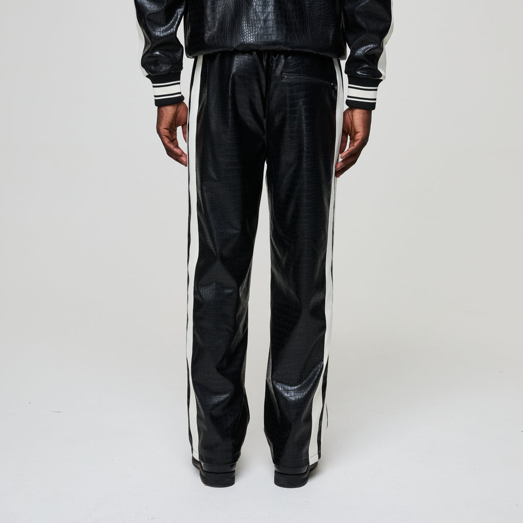 Black leather tracksuit with white stripes on a light gray background
