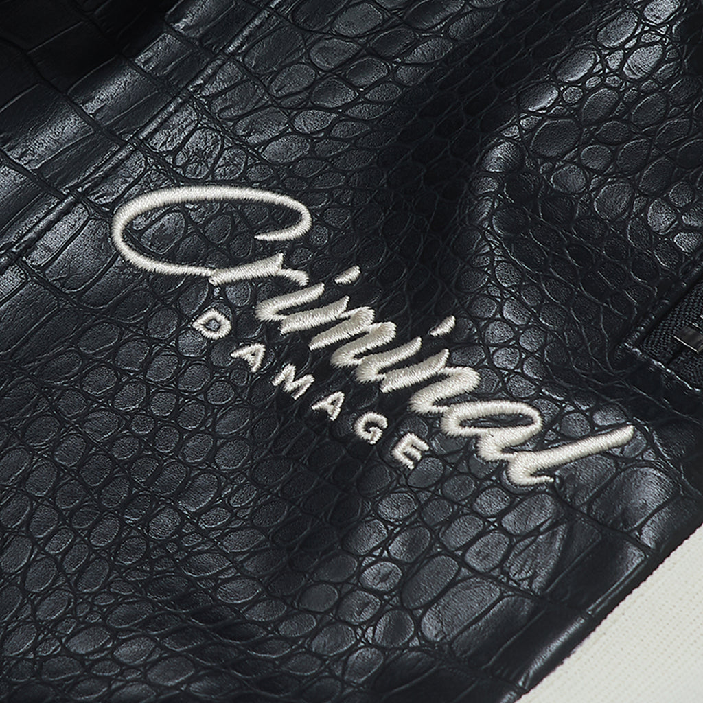 Black textured surface with 'Criminal Damage' branding.