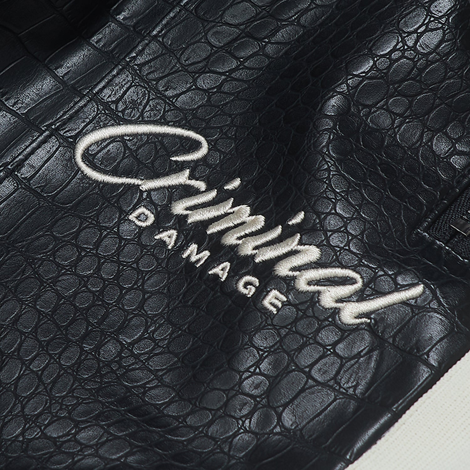 Black textured surface with 'Criminal Damage' branding.