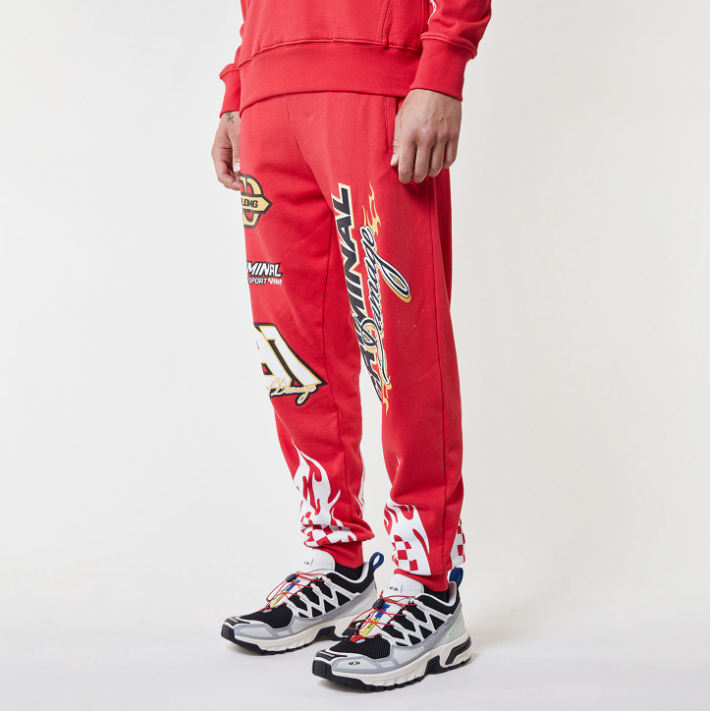Red Criminal Damage tracksuit with brand logos on a white background