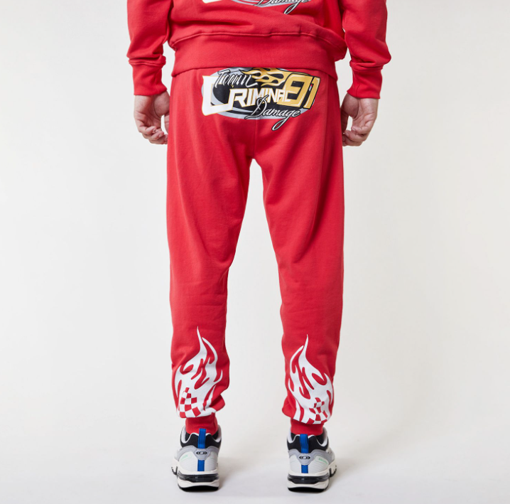 Red Criminal Damage tracksuit with brand logos on a white background