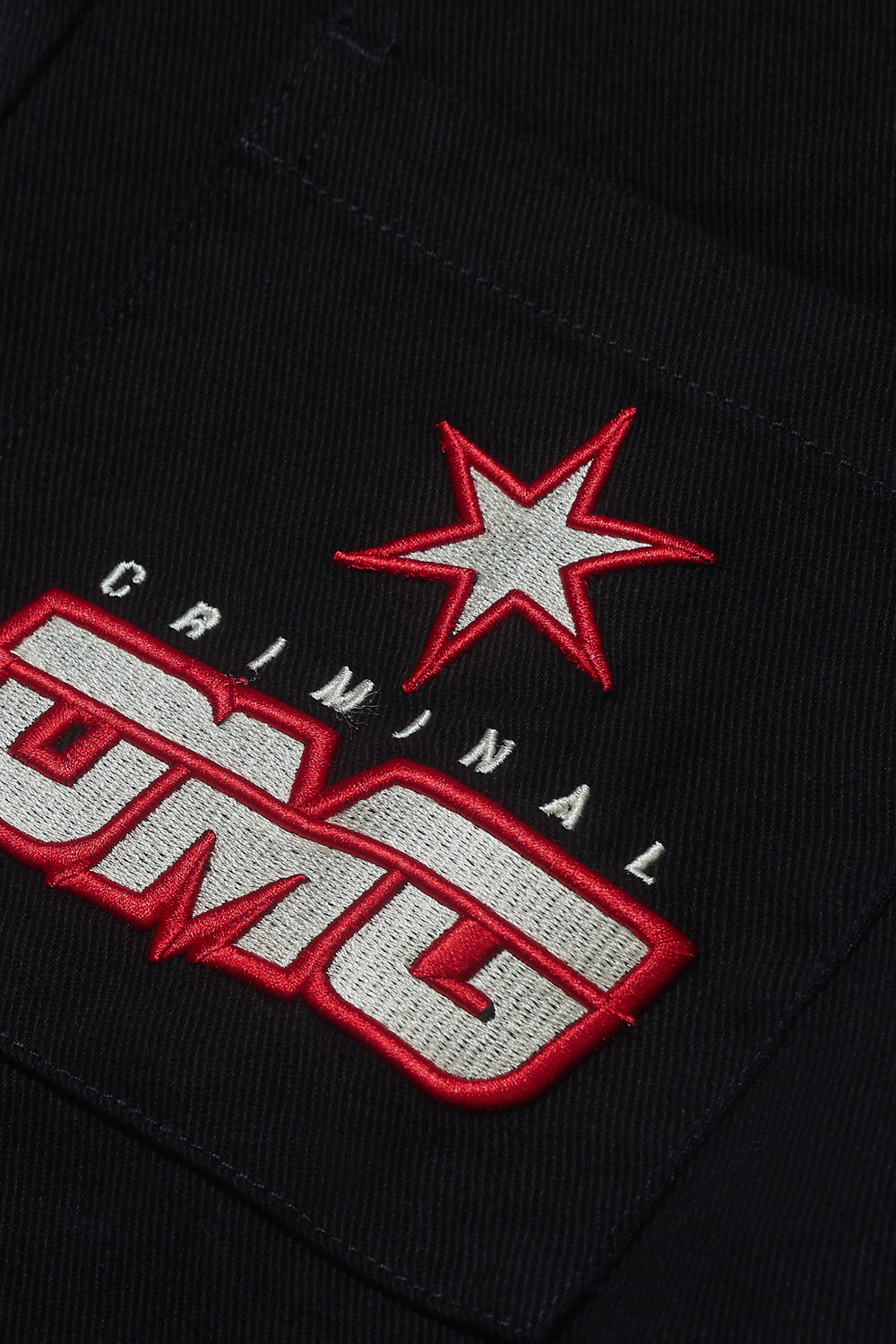 Close up of Criminal Damage patch logo on shirt