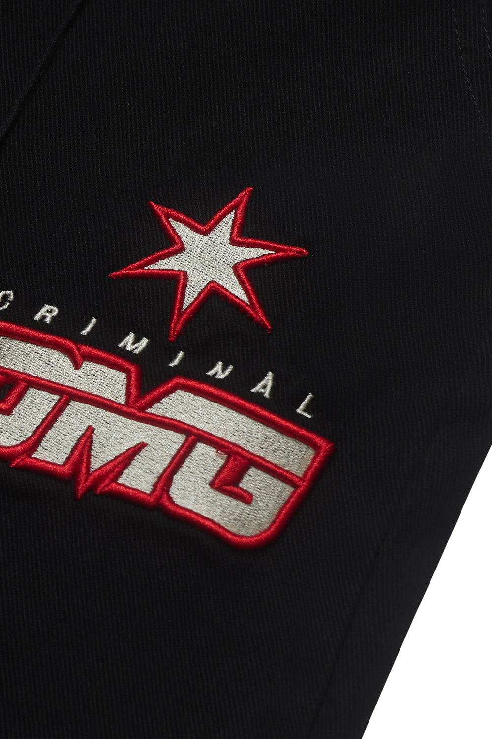 Close up of Criminal Damage path logo on shorts 