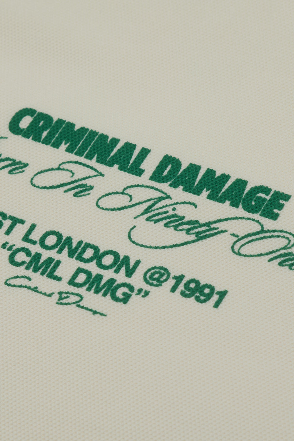 Criminal Damage text in green on a beige background