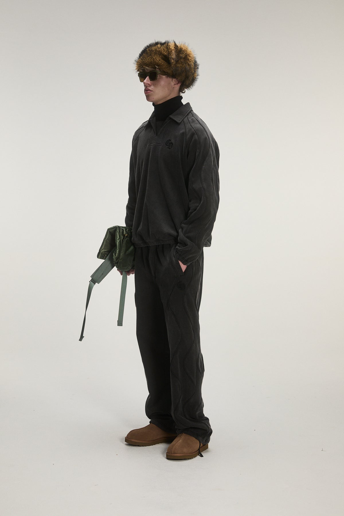 male model wearing criminal damage track suit