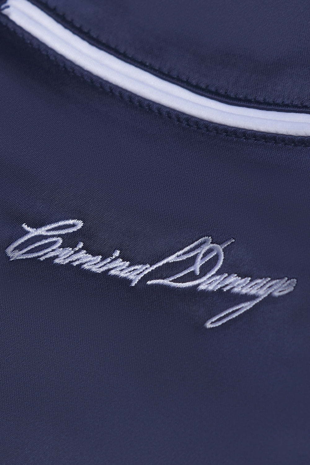 Close up of Criminal Damage embroidered logo on shirt