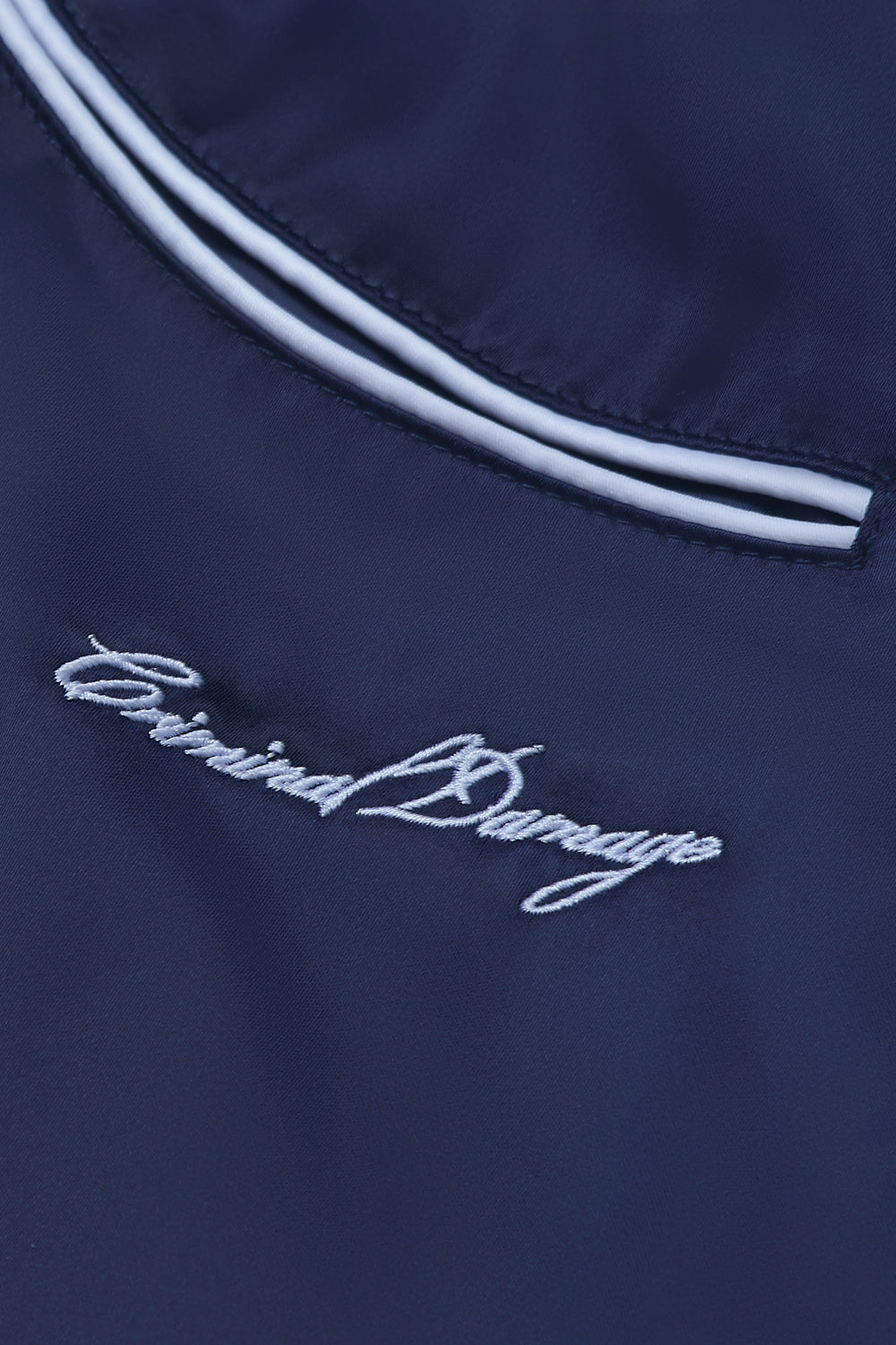 Close up of Criminal Damage branding on shorts