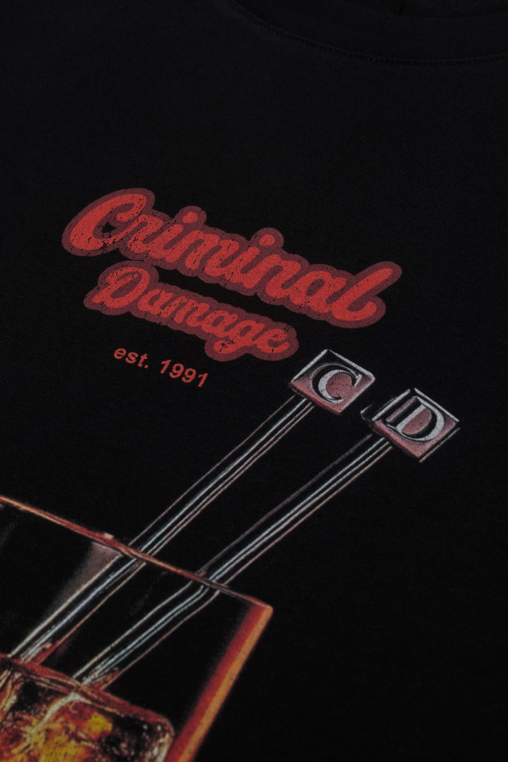 Close up of Criminal Damage whisky graphic on t-shirt